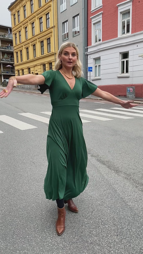 Lang grønn kjole fra Dianas Vintage. V-hals, klokkeermer og midjebelte.
